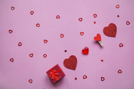 Many hearts and a box with a gift next to them. Concept for Valentines Day or another love event in a minimal style.の写真素材