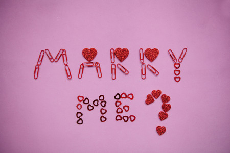Question marry me from the hearts on a pink background.の写真素材