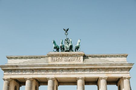 Closeup of the Brandenburg Gate against the blue sky. This is one of the attractions of Berlin in Germany.の写真素材