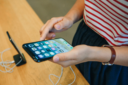 Berlin, August 29, 2018: The buyer looks to buy a new modern iPhone X in the official Apple store in Berlin in Germany.のeditorial素材