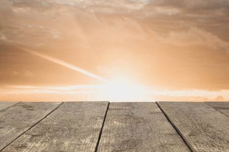 Wooden board or table or surface or floor against the sunset sky - can be used to montage or showcase your products.の写真素材