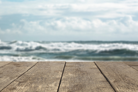 Wooden board or table or surface or floor against the background of the sea or ocean - can be used to montage or showcase your products.の写真素材