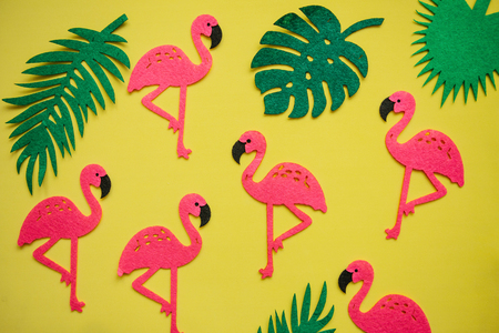 Tropical summer bright background with many plant leaves and flamingos.の写真素材
