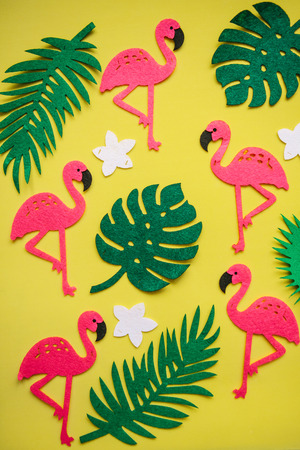 ropical summer bright background with many plant leaves, flowers and flamingos.の写真素材
