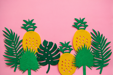 Tropical summer bright background with lots of pineapples and leaves.の写真素材
