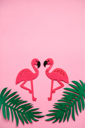 Flamingos and leaves on a pink background. Summer design. Above there is a place for text.の写真素材