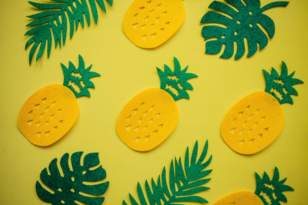 Tropical summer bright background with lots of pineapples and leaves.の写真素材