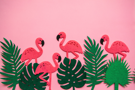 Flamingos and leaves on a pink background. Summer design. Above there is a place for text.の写真素材