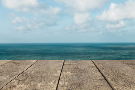 Wooden board or table or surface or floor against the background of the sea or ocean - can be used to montage or showcase your products.の写真素材