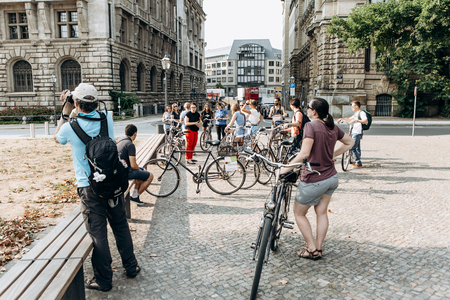 Germany, Leipzig, September 6, 2018: A group of tourists riding bikes sightseeing. Excursion on the bikeのeditorial素材