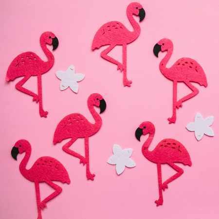Many flamingos and flowers on a pink background in minimal style.の写真素材