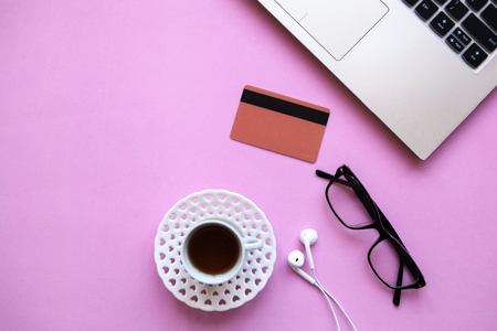 Laptop, credit card and various things on a pink background. Concept of e-commerce and online shopping. Nearby there is a place for text.の写真素材