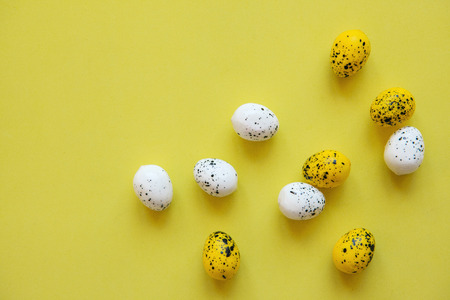 A lot of colorful Easter eggs on a yellow background. Festive Easter background.の写真素材