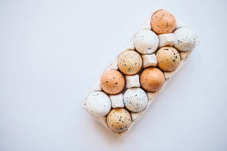 A set of eggs in a container on a white background. Easter celebration.