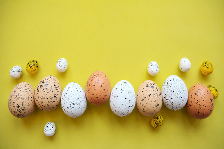 Set of colored eggs on a yellow background. Festive Easter concept. Above there is a place for text.の写真素材