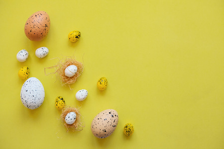 Set of colored eggs on a yellow background. Festive Easter concept. Nearby there is a place for text.の写真素材