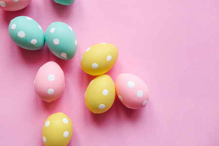 A lot of colorful Easter eggs on a pink background. Festive Easter background.の写真素材