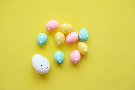 A lot of colorful Easter eggs on a yellow background. Festive Easter background.の写真素材
