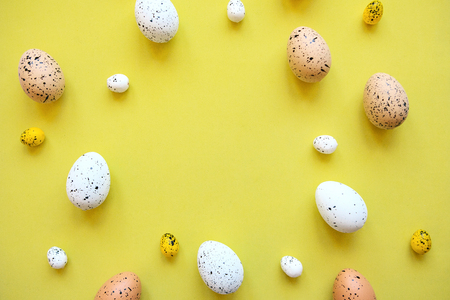 Set of colored eggs on a yellow background. Festive Easter concept. In the middle there is a place for text.の写真素材