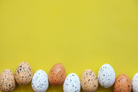 Set of colored eggs on a yellow background. Festive Easter concept. Above there is a place for text.の写真素材