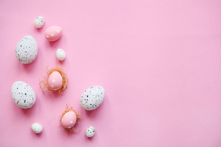 Set of colored eggs on a pink background. Festive Easter concept. Nearby there is a place for text.の写真素材