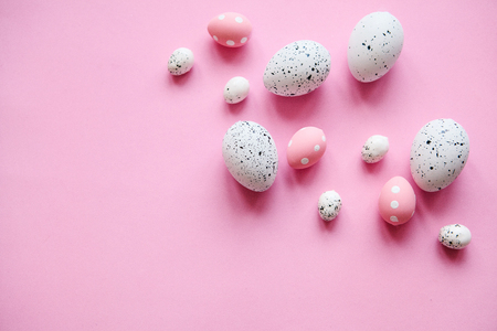 Set of colored eggs on a pink background. Festive Easter concept. Nearby there is a place for text.の写真素材
