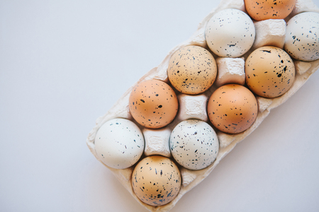 A set of eggs in a container on a white background. Easter celebration.の写真素材
