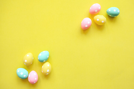 A lot of colorful Easter eggs on a yellow background. Festive Easter background.の写真素材