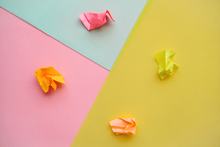 Crumpled sheets of colored paper on a multi-colored background. Lack of ideas and frustration.の写真素材