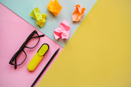 Glasses, pencil and other items on a colorful background. Nearby there is a place for text.の写真素材