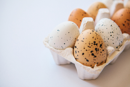 A set of eggs in a container on a white background. Easter celebration.の写真素材