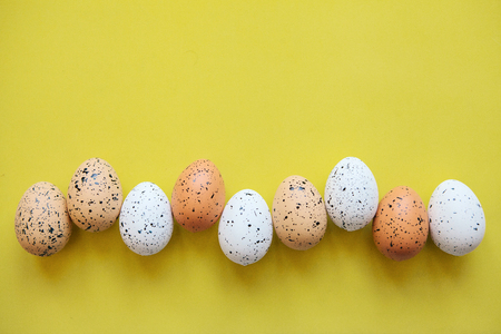 Set of colored eggs on a yellow background. Festive Easter concept. Above there is a place for text.の写真素材