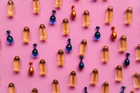 Capsule background with Omega 3, hyaluronic acid and coenzyme. Caring for the health of the skin and body.の写真素材