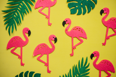 Tropical summer bright background with many plant leaves and flamingos.の写真素材