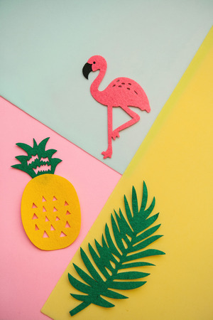 Flamingo, tropical leaf and pineapple on a colored background. Summer background.の写真素材