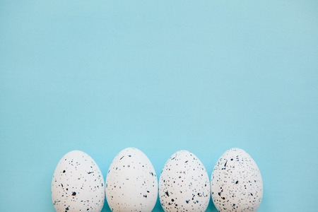Set of colored eggs on a blue background. Festive Easter concept. Above there is a place for text.