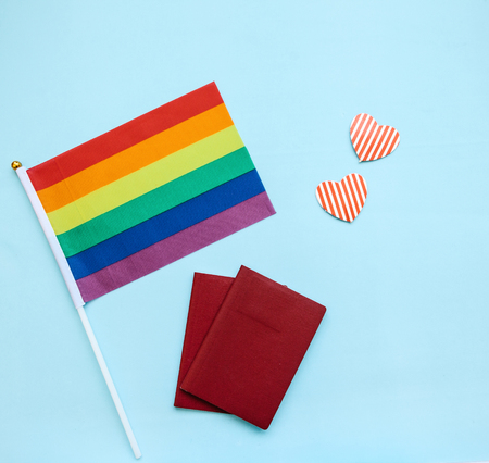 The multi-colored flag is a rainbow-colored or LGBT flag next to a passport. LGBT migration.の写真素材