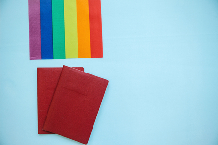 The multi-colored flag is a rainbow-colored or LGBT flag next to a passport. LGBT migration.の写真素材