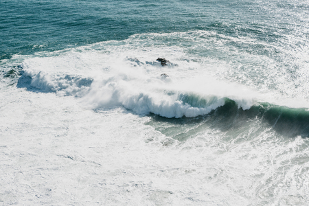 Wave and foam in the sea or ocean close-up. Beautiful nature.の写真素材