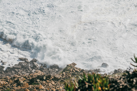 Wave and foam in the sea or ocean near the shore close-up. Beautiful nature.の写真素材
