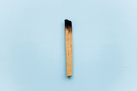 Wooden stick Palo Santo on a blue background. Used in aromatherapy and religious rites and meditations.の写真素材