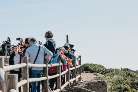Portugal, Sintra, June 26, 2018: A group of people or tourists admire the sights and take pictures of the beautiful view of Cape Roca.のeditorial素材