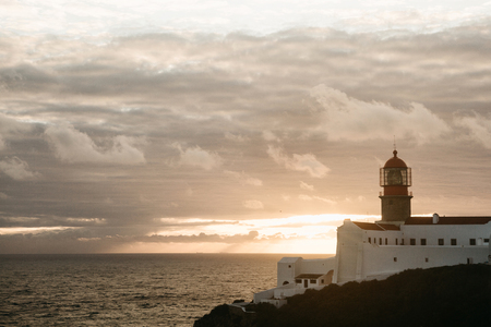 View of the lighthouse and cliffs at Cape St. Vincent in Portugal at sunset. The most south-western point of Europe.の写真素材