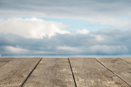 Wooden board or table or surface or floor against the sky - can be used to montage or showcase your productsの写真素材