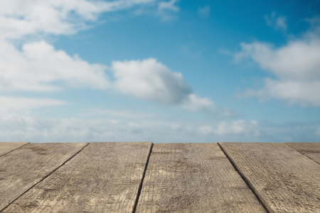 Wooden board or table or surface or floor against the sky - can be used to montage or showcase your productsの写真素材