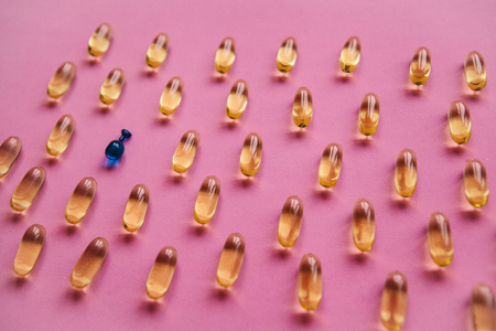 Capsule background with Omega 3, hyaluronic acid. Caring for the health of the skin and body.の写真素材