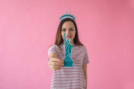 Girl as a statue of liberty - concept of learning American language or immigration or work and travel.の写真素材