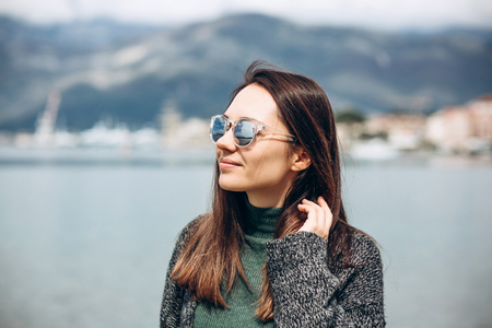 Portrait of a young beautiful girl in sunglasses on the background of the sea.の写真素材