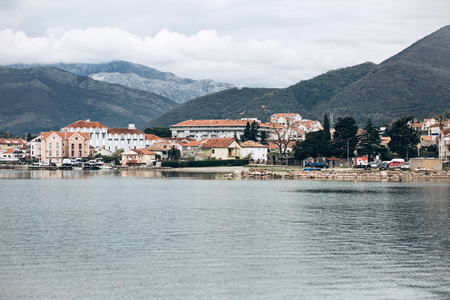 Beautiful view of the urban architecture or houses near the sea and the mountains in the coastal city of Tivat in Montenegro.の写真素材