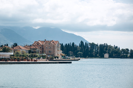 Beautiful view of the architecture of the coastal city of Tivat in Montenegro against the backdrop of the sea and mountains.の写真素材